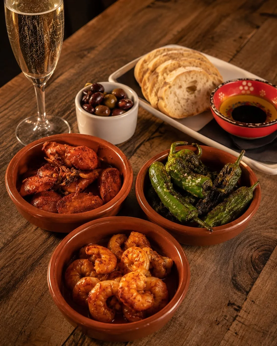 Several tapas dishes arranged on a wooden table